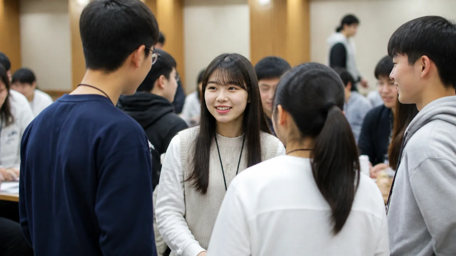 Young Korean university students introducing themselves and talking at a first meeting