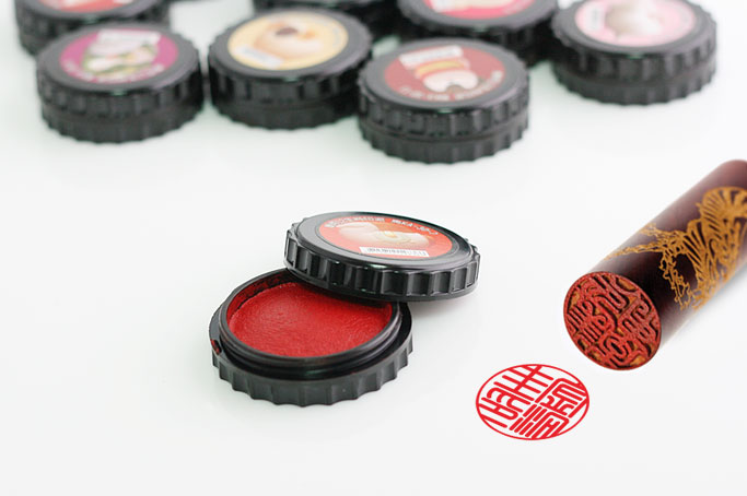 A dojang seal with its red ink pad and stamped impression. Photo: Korea Stamp
