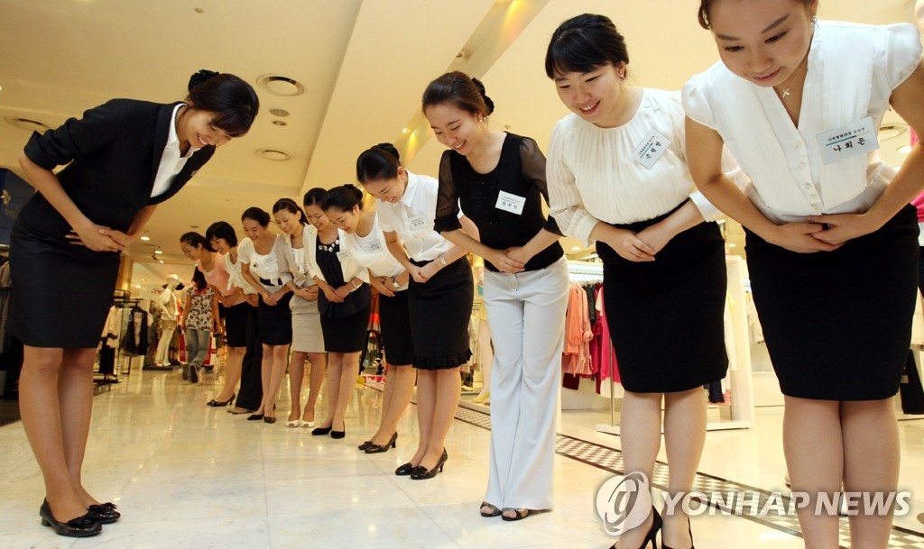 Department store staff bowing to greet customers in South Korea. Photo: Yonhap News