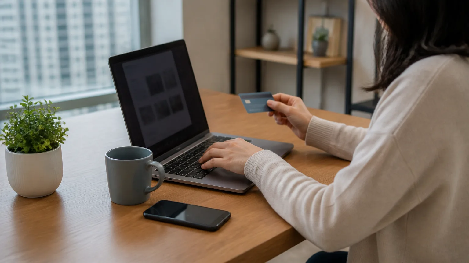 Person entering card details on an online payment screen on a laptop
